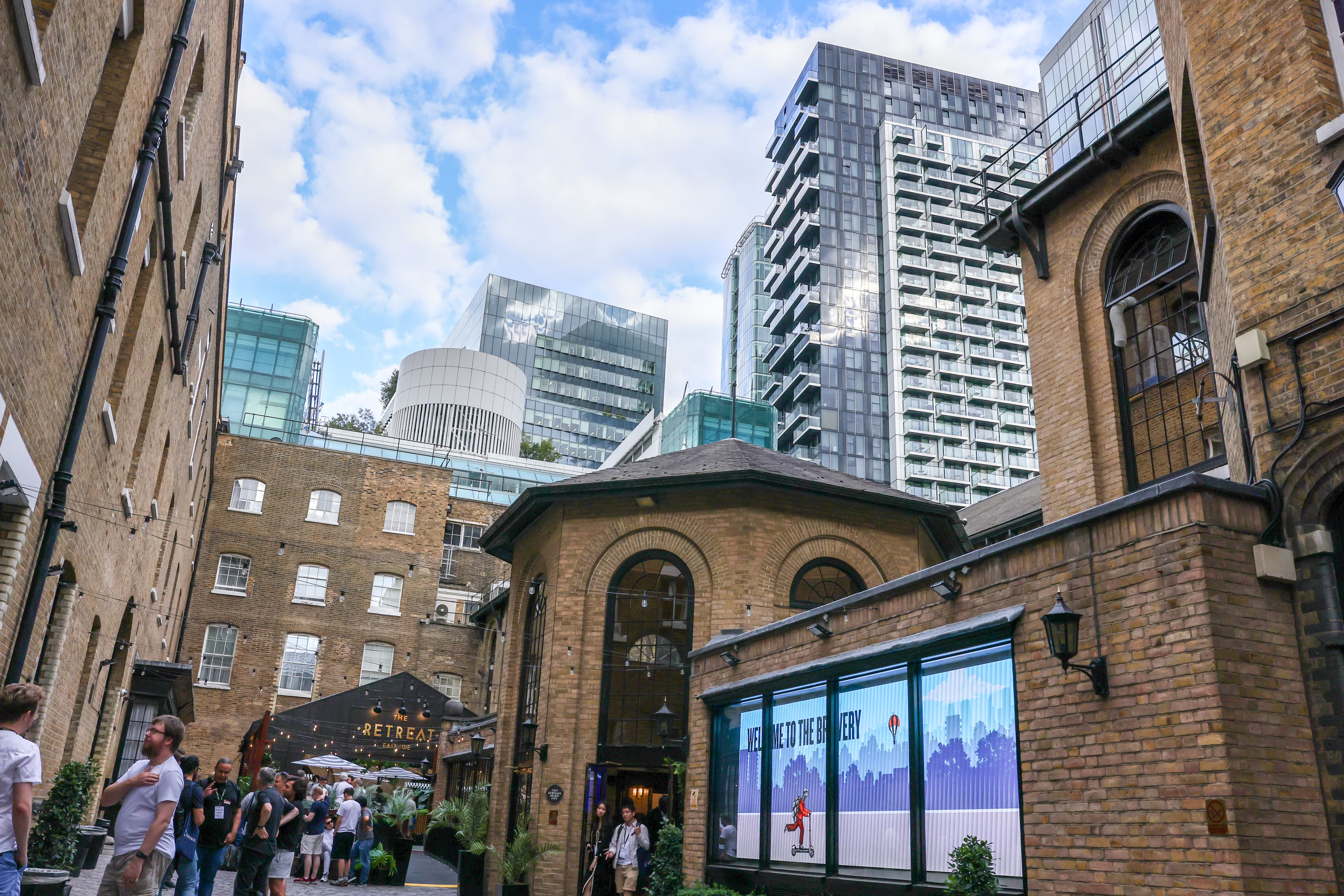 The Brewery venue courtyard with historic brick buildings and City of London skyline