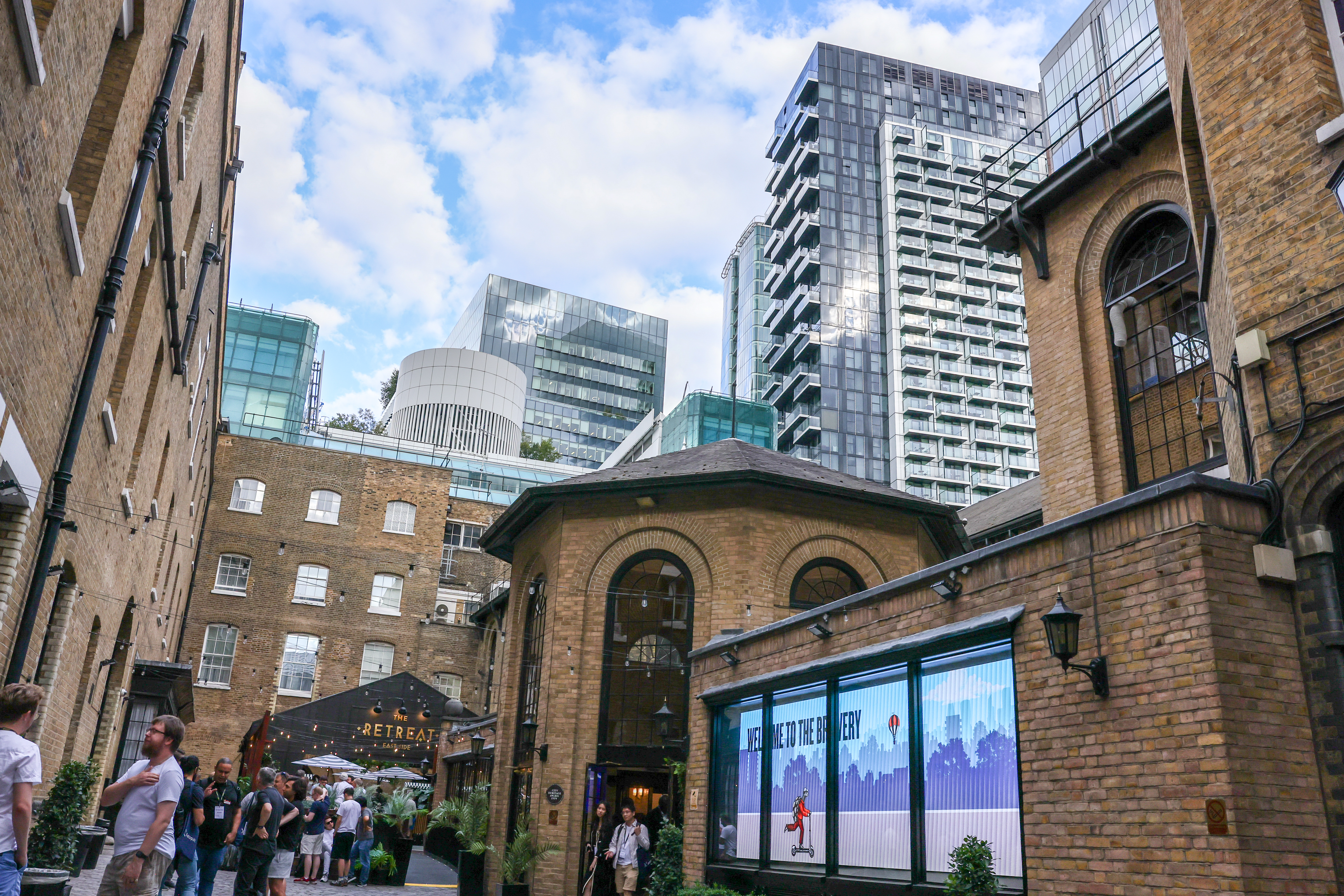 The Brewery venue courtyard with historic brick buildings and City of London skyline